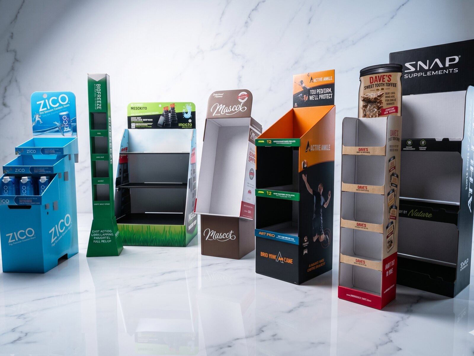Retail floor displays and shelf-ready endcaps from Rox — ZICO, Snap Supplements, Dave's, Muscoé and other CPG brand standees on a polished retail floor